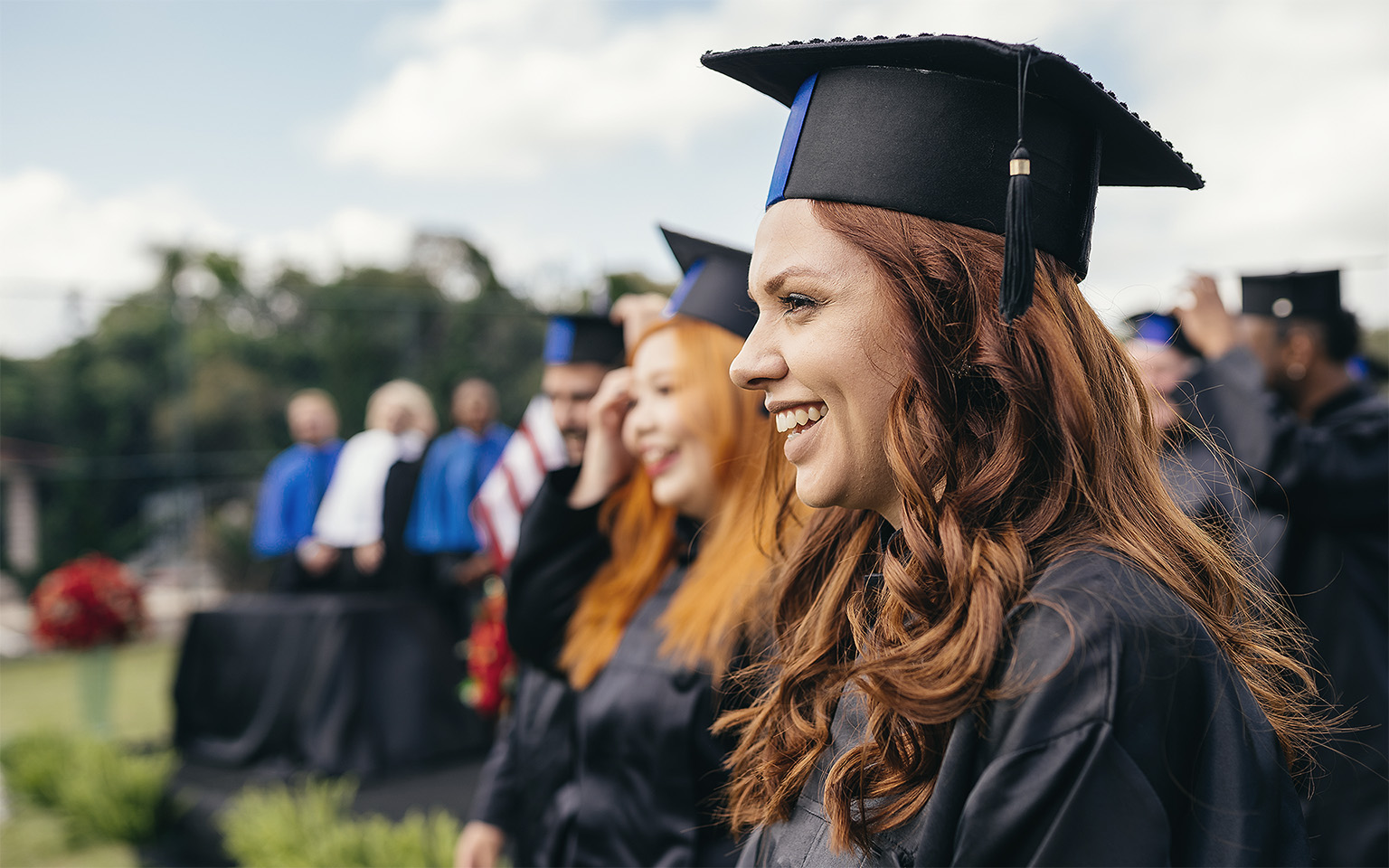 Smiling graduate at graduation ceremony