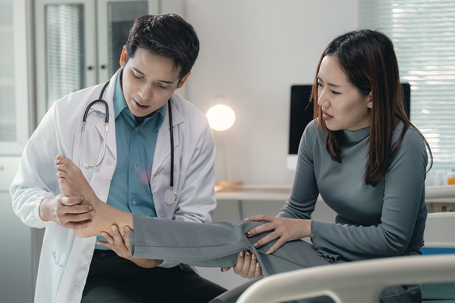 Doctor examining injured ankle