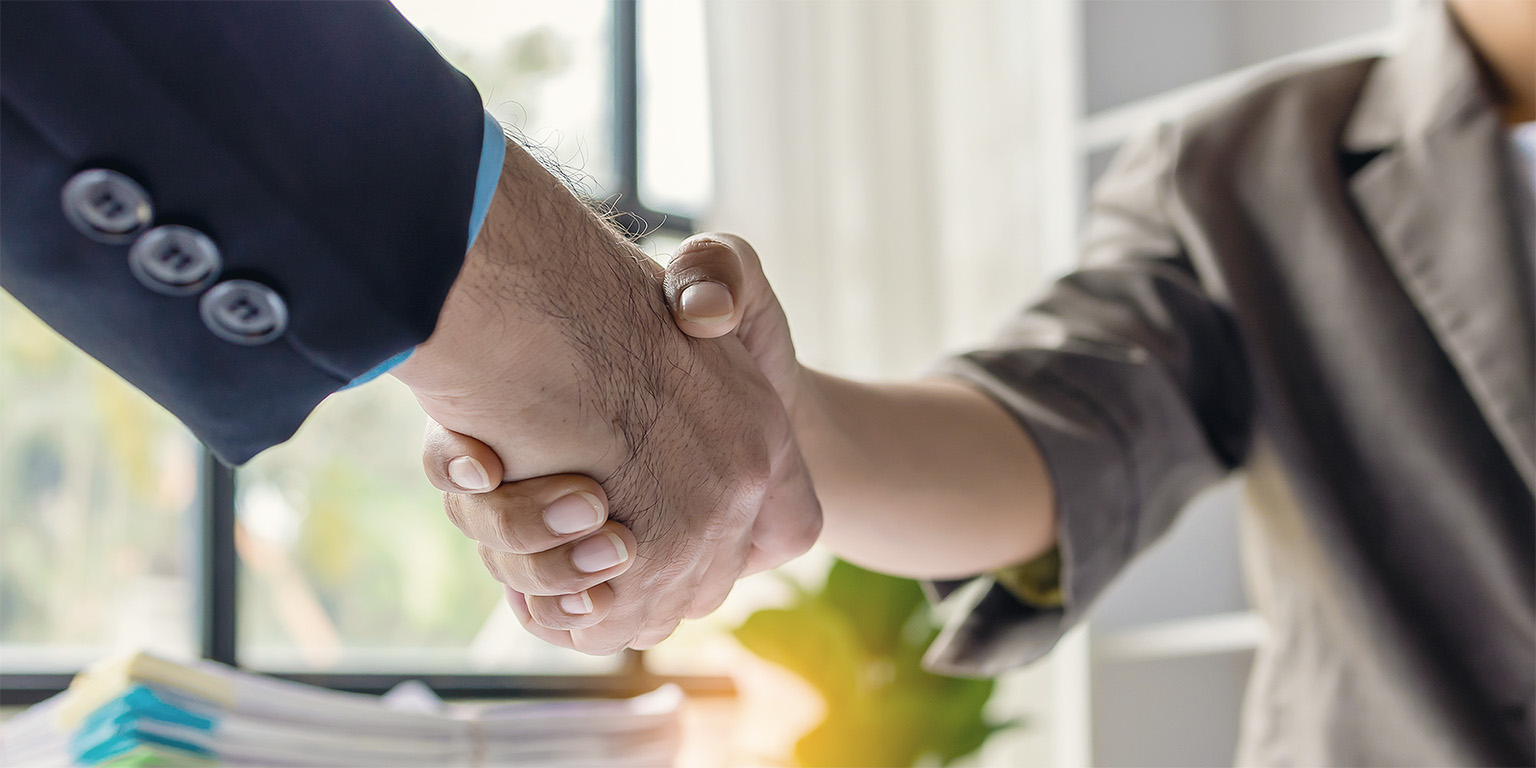 Business handshake in office