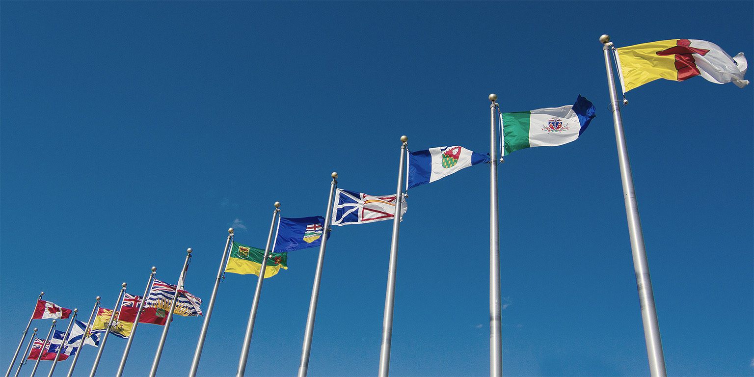 A line of flags of Canadian provinces
