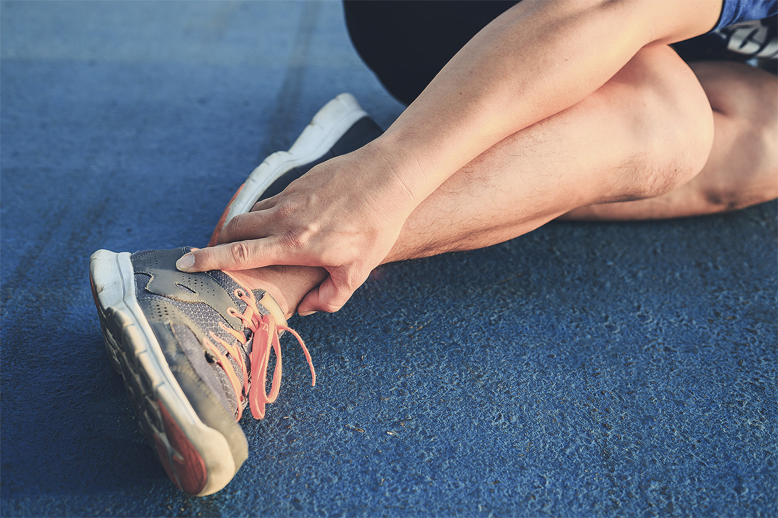 Runner holding injured ankle
