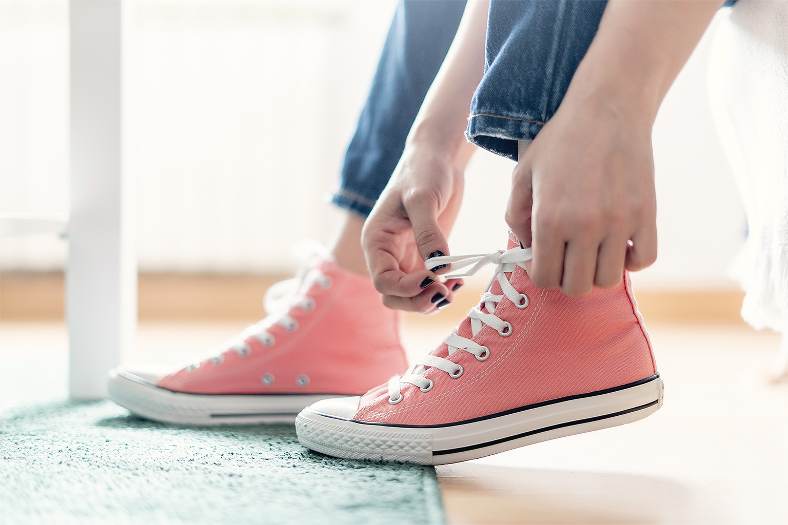 Woman tying sneaker shoelaces