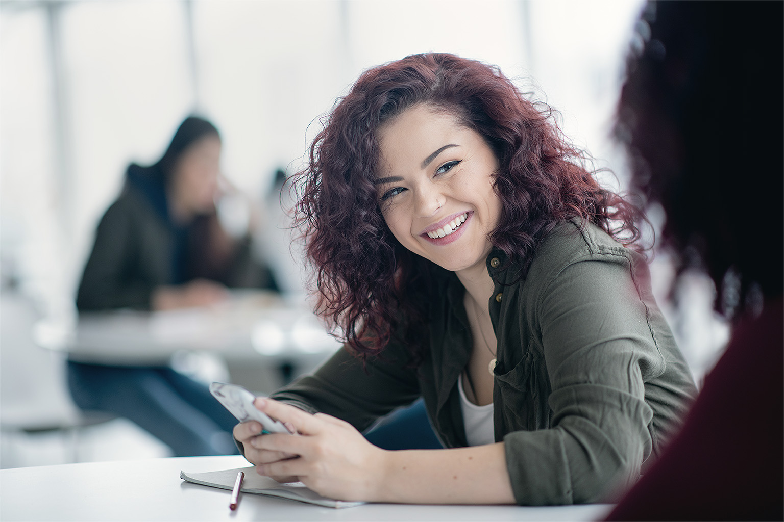 Woman smiling holding phone